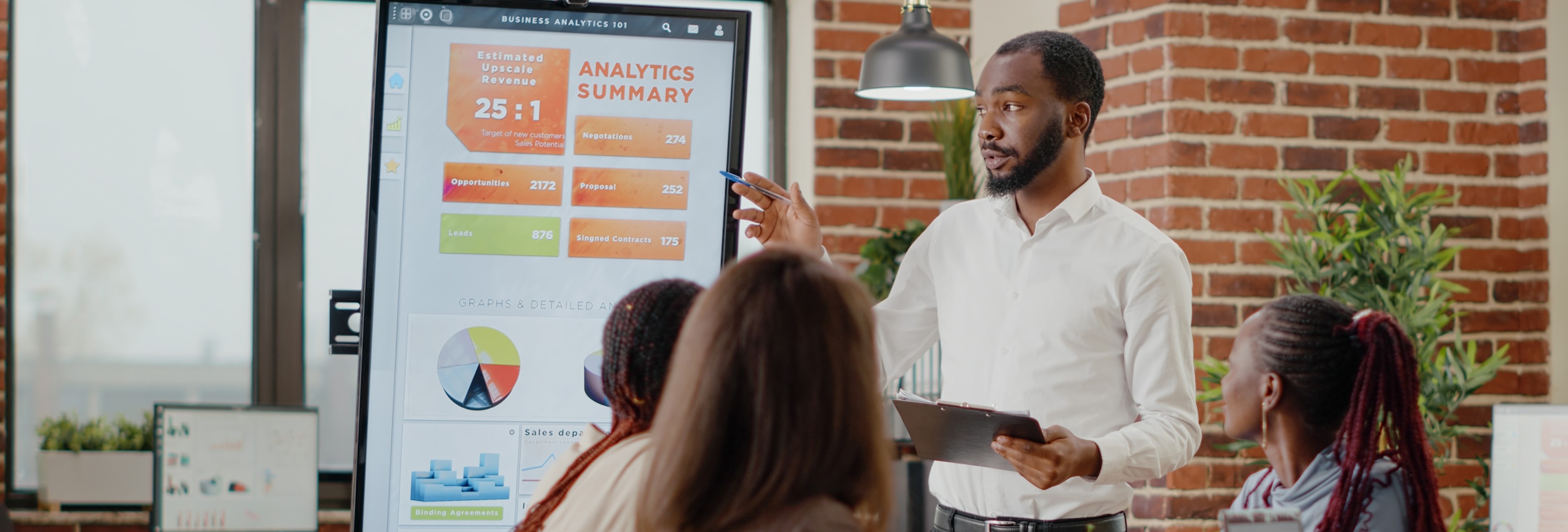 a man presenting to his team at a meeting